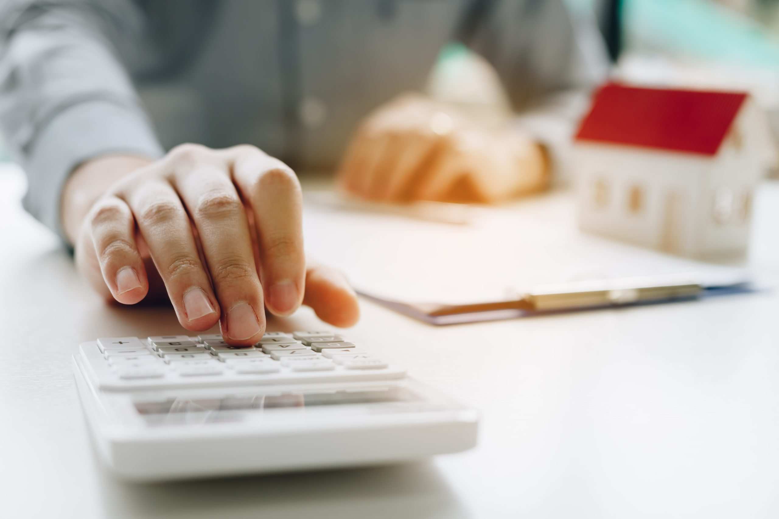 Mortgage Broker computing on a calculator debunking mortgage myths
